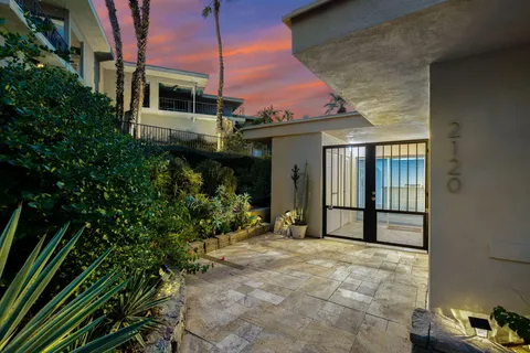 a view of a chairs and table in the balcony