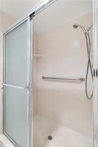 a bathroom with a glass shower door