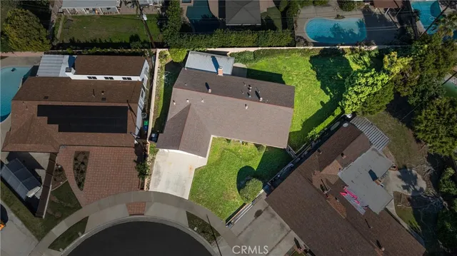 an aerial view of residential house with outdoor space and trees