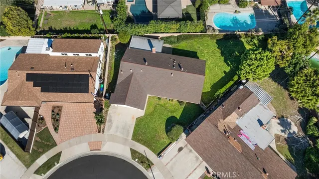 an aerial view of a house with a swimming pool