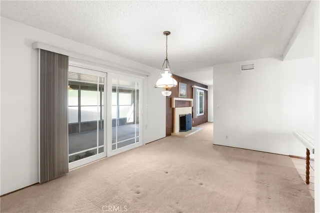 a view of a big room with windows and chandelier
