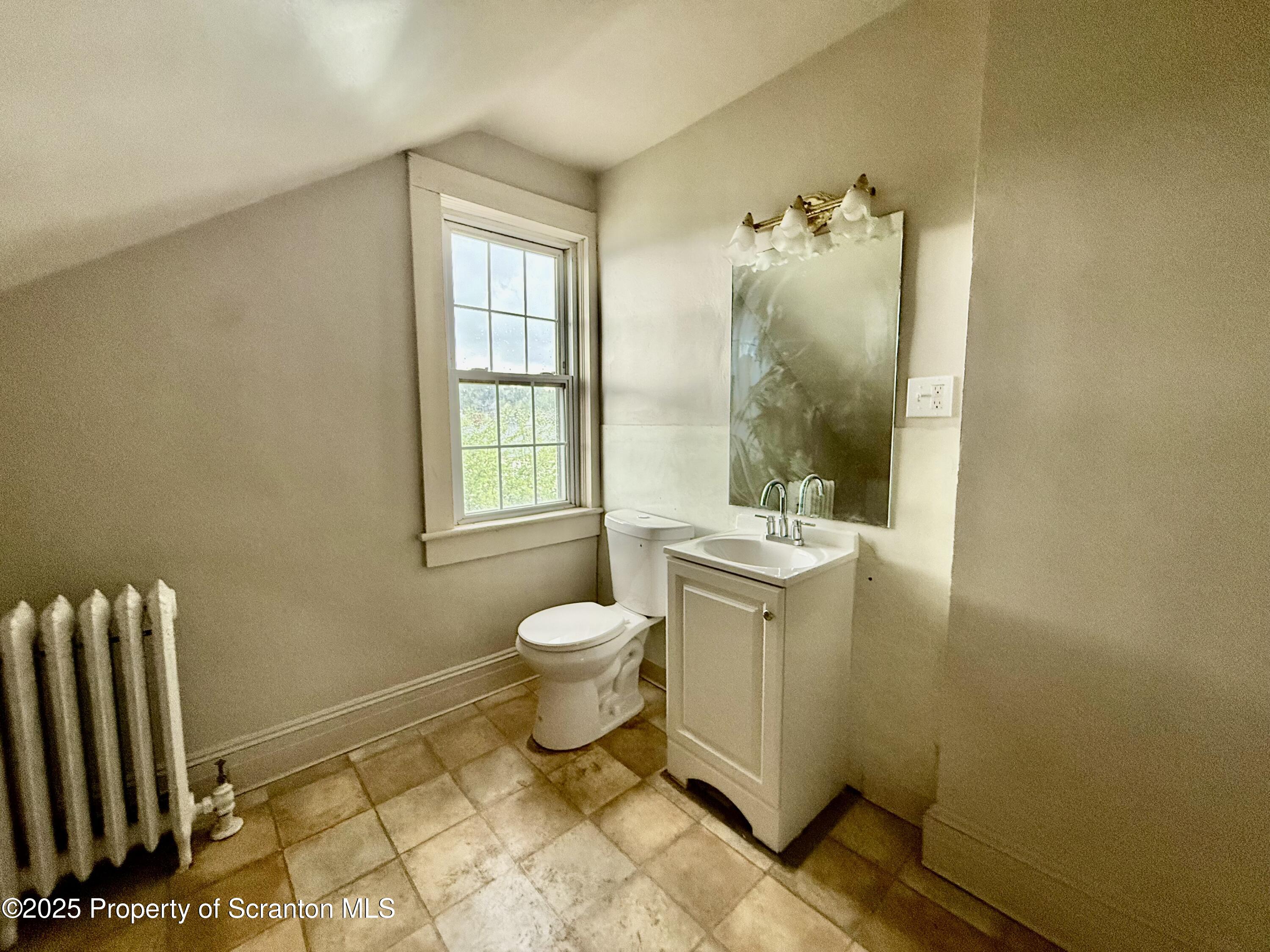 611 Harrison Avenue Scranton, PA 18510 - Photo 15 of 18 a bathroom with a sink toilet and mirror