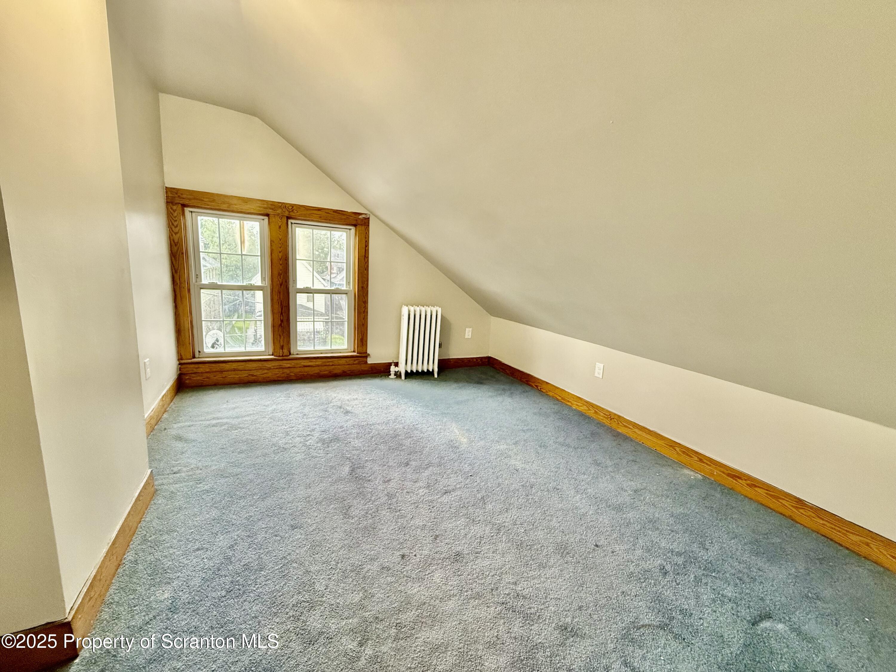 611 Harrison Avenue Scranton, PA 18510 - Photo 17 of 18 an empty room with wooden floor and white walls