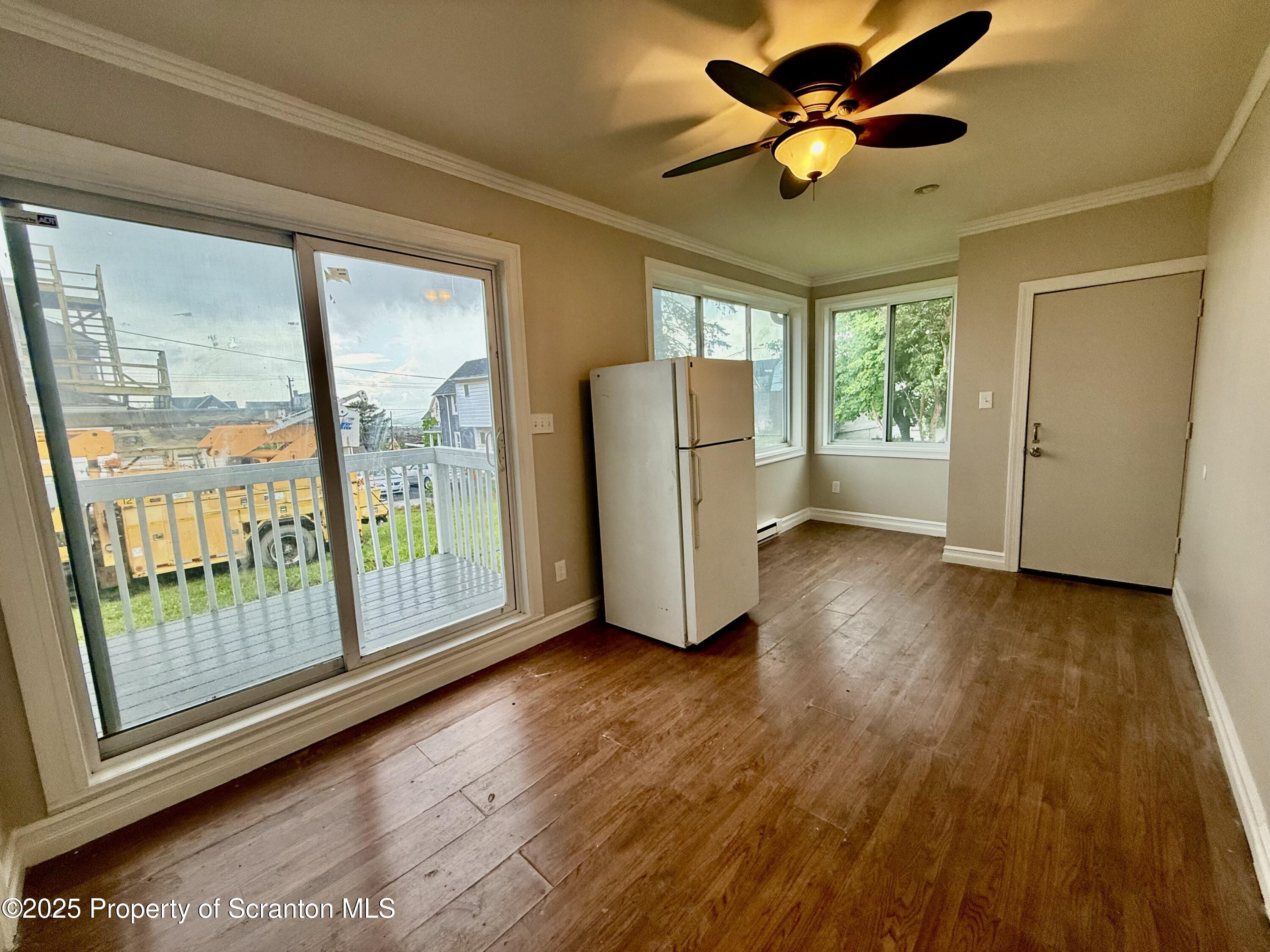 611 Harrison Avenue Scranton, PA 18510 - Photo 6 of 18 a view of empty room with wooden floor and fan