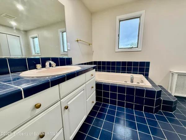 a kitchen with kitchen island a counter top space wooden floor and stainless steel appliances