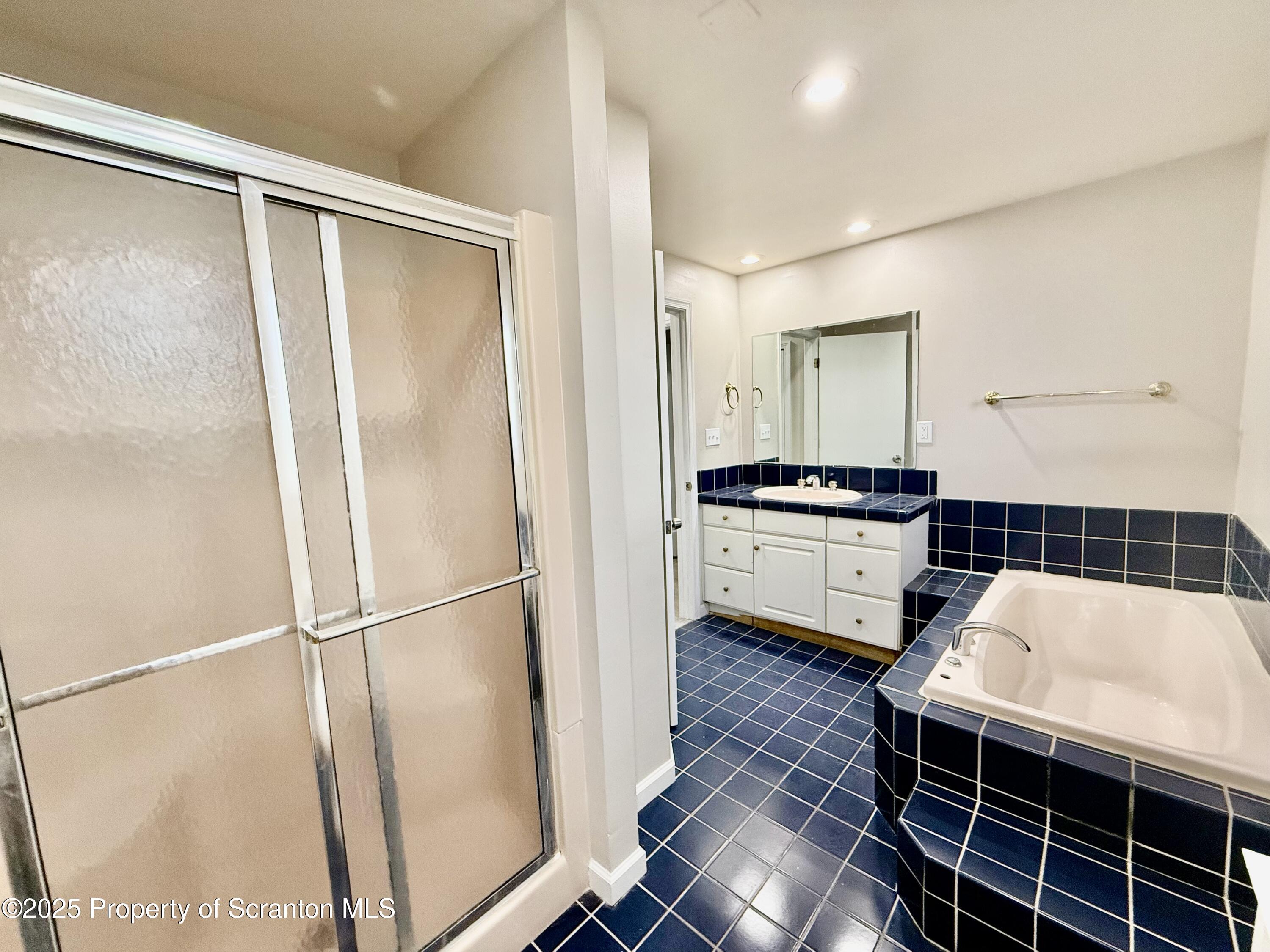 611 Harrison Avenue Scranton, PA 18510 - Photo 9 of 18 a kitchen with kitchen island a counter top space wooden floor and stainless steel appliances