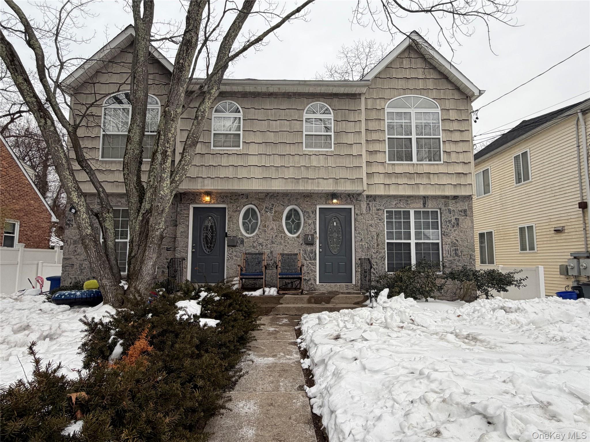 62 A Linwood Road North Port Washington, NY 11050 - Photo 1 of 1 a front view of a house with a yard covered in snow