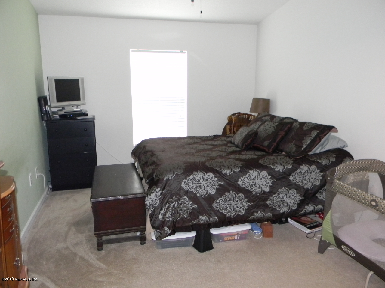 7920 Merrill Road, Unit 714 Jacksonville, FL 32277 - Photo 9 of 12 a bedroom with a bed and a tv