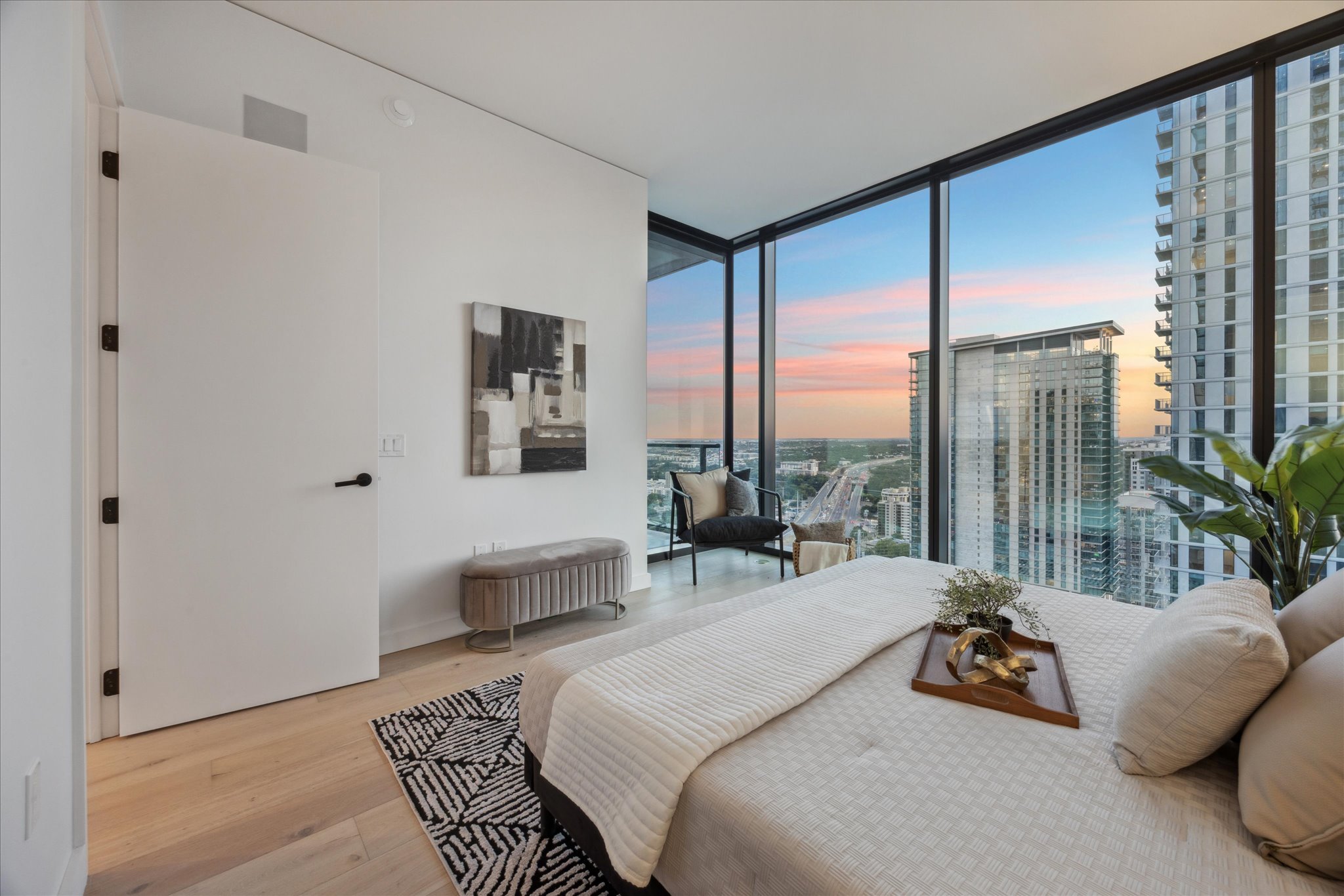610 Davis Street, Unit 3102 Austin, TX 78701 - Photo 13 of 40 a bedroom with a bed and glass window