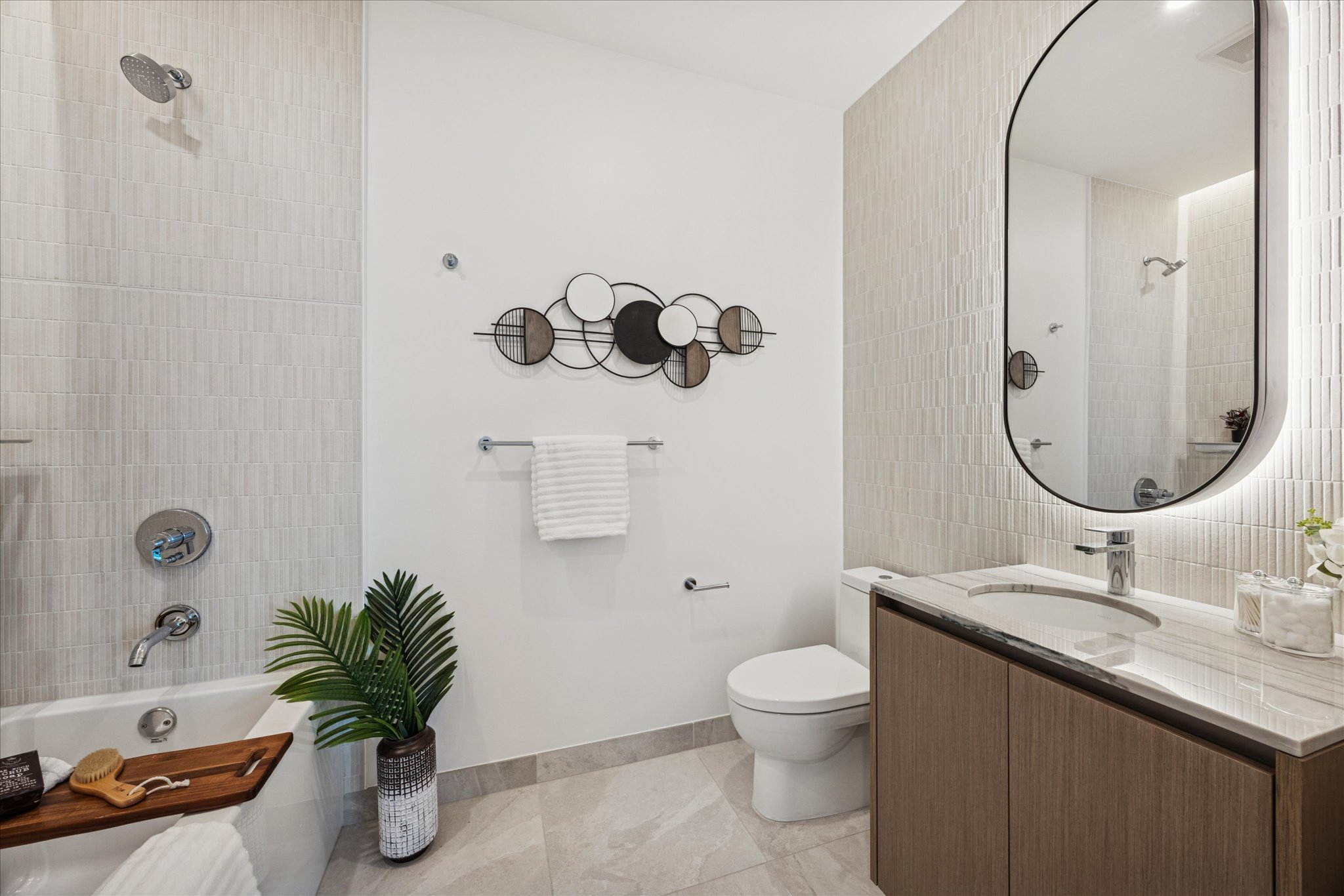 610 Davis Street, Unit 3102 Austin, TX 78701 - Photo 19 of 40 a bathroom with a granite countertop sink a toilet and a mirror