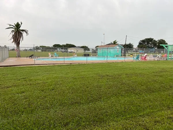 a view of a green field with an ocean view