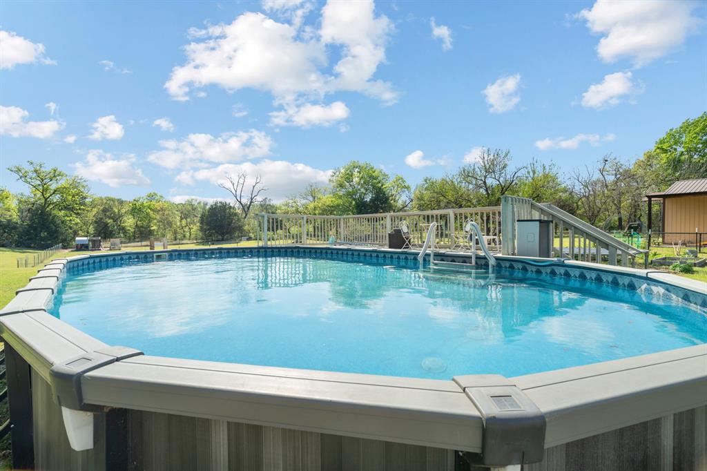 112 Waterfall Court Azle, TX 76020 - Photo 34 of 40 a view of a swimming pool with a yard