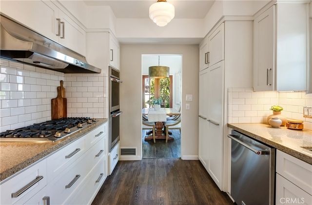 a kitchen with stainless steel appliances granite countertop a stove and a refrigerator