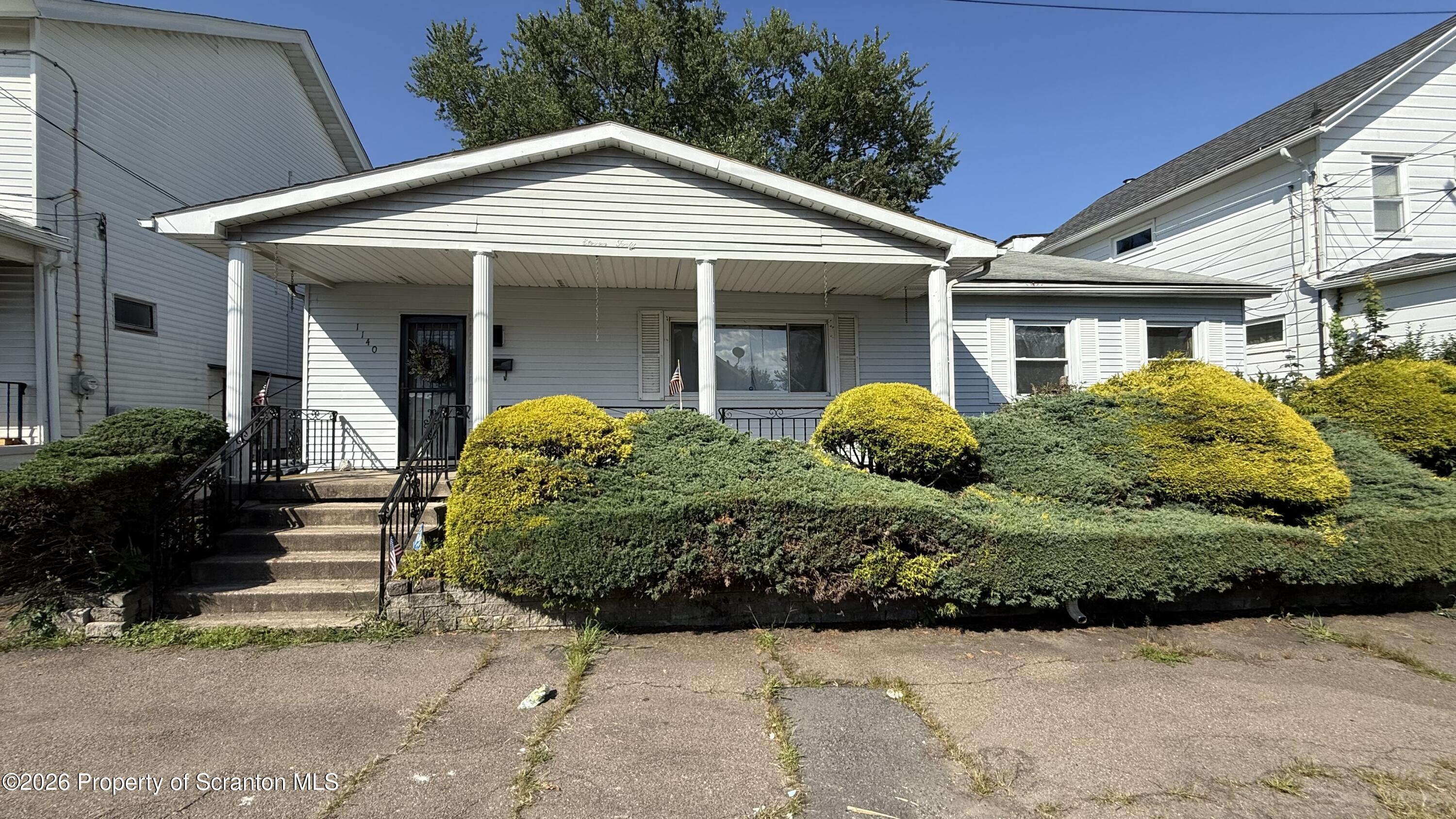 1140 Hampton Street Scranton, PA 18504 - Photo 1 of 8 a front view of a house with a yard
