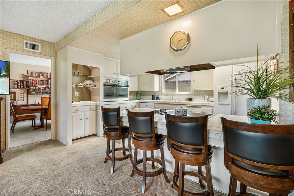 1423 La Canada Drive Brea, CA 92821 - Photo 20 of 43 a dining room with stainless steel appliances kitchen island granite countertop a sink and a refrigerator