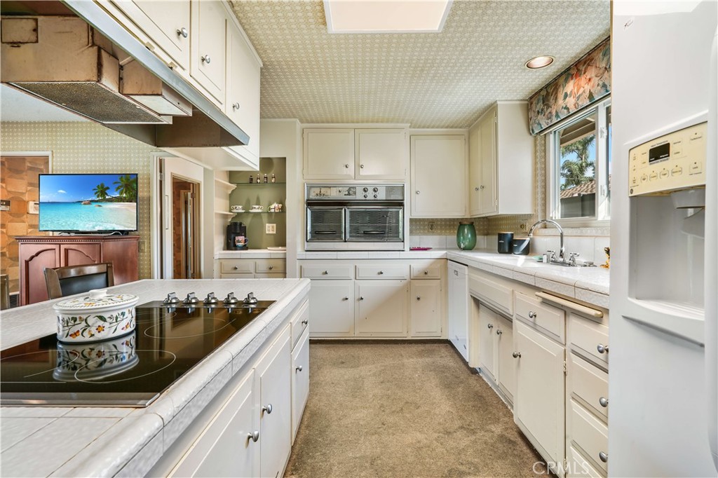 1423 La Canada Drive Brea, CA 92821 - Photo 22 of 43 a kitchen with stainless steel appliances granite countertop a stove and a sink