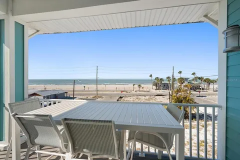 a living room with fireplace furniture and a large window