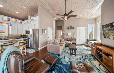 a bedroom with furniture and a large window