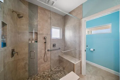a bathroom with a granite countertop sink a toilet and a mirror