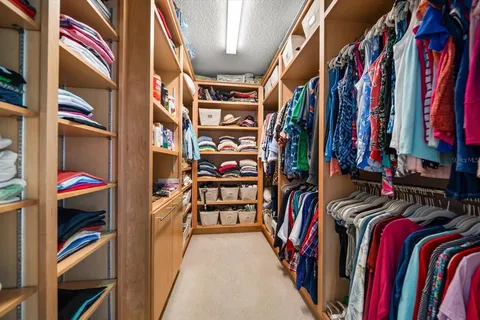 a bathroom with a granite countertop sink a toilet a mirror and shower