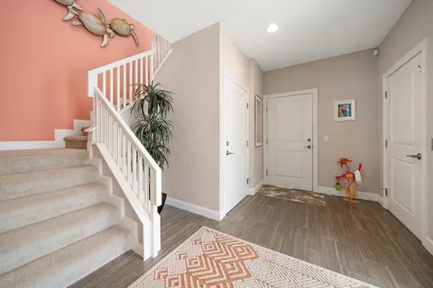 a view of a hallway with wooden floor and a livingroom view