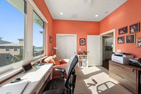 a bedroom with a bed and a refrigerator