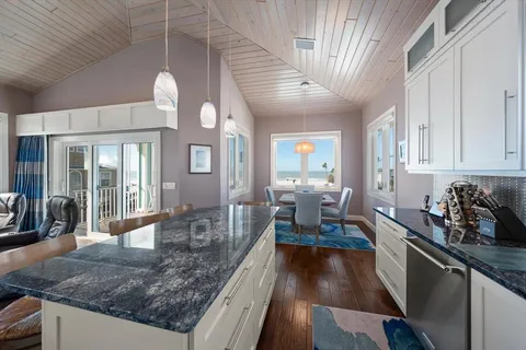 a large kitchen with lots of counter space a sink and appliances