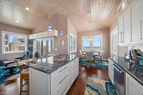a living room with furniture a clock and a ceiling fan
