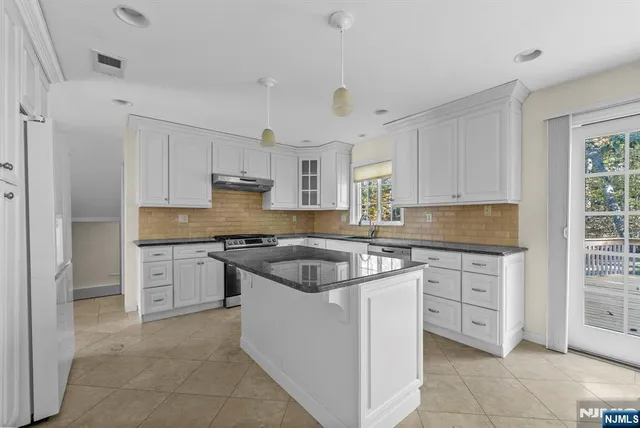 a bathroom with a granite countertop toilet sink and mirror