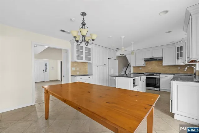 a view of entryway with wooden floor and a bathroom