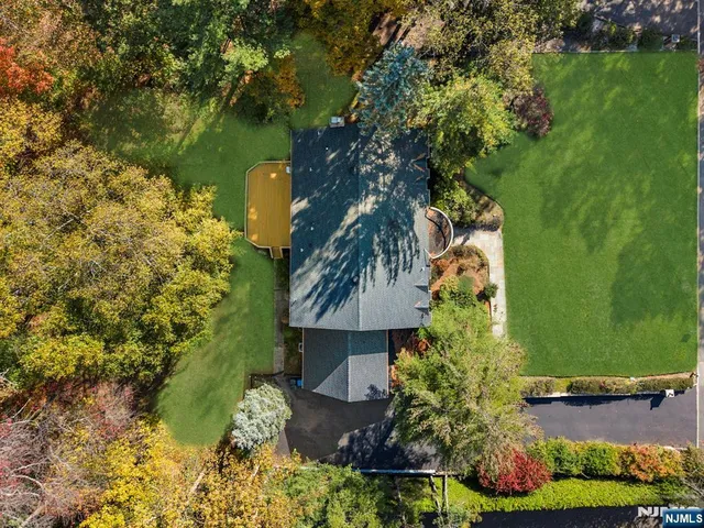 a front view of a house with a yard and trees