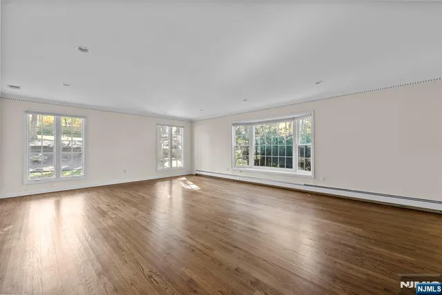 a view of a room with wooden floor and window