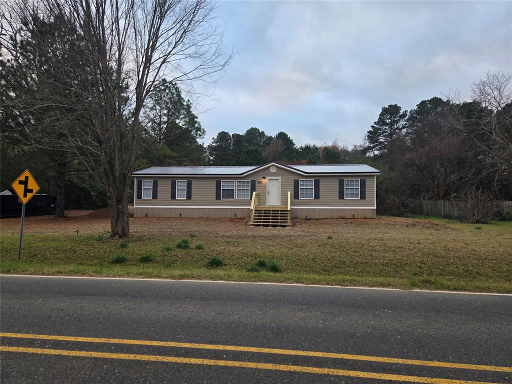 909 Old Arcadia Road Minden, LA 71055 - Photo 1 of 21 a front view of a house with garden