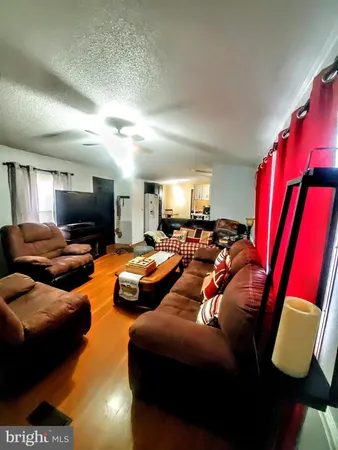 a bedroom with furniture and a flat screen tv