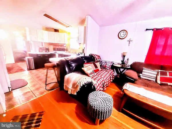 a living room with furniture and a bed