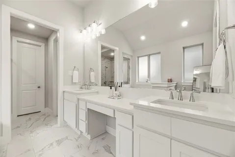 a bathroom with double vanity sinks and a mirror