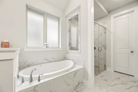 a bathroom with a tub and shower