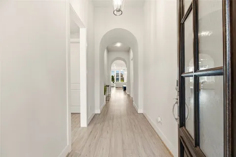 a view of a hallway view with wooden floor and staircase