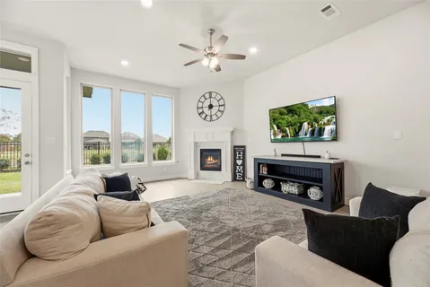 a living room with furniture a fireplace and a flat screen tv