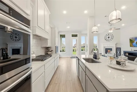 a kitchen with a sink stove and cabinets