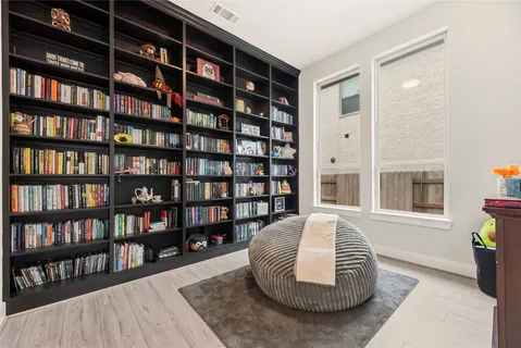 a living room with furniture and a book shelf