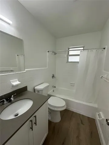a bathroom with a double vanity sink toilet mirror and shower
