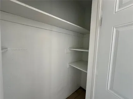 a view of an empty walk in closet