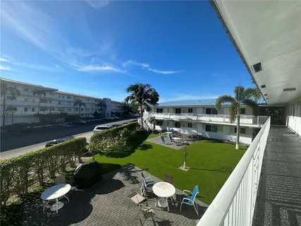 a view of a swimming pool and outdoor seating