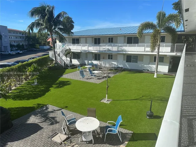 a front view of a house with swimming pool garden and patio