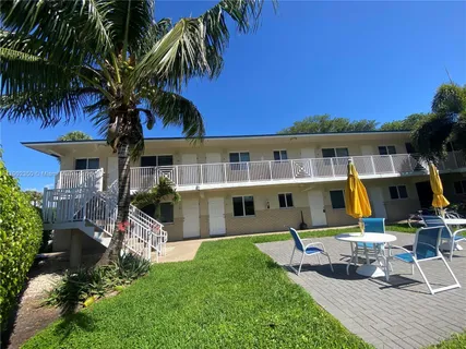 a view of backyard with swimming pool and seating space