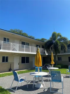 a view of a house with swimming pool and sitting area