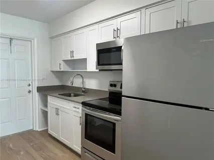 a kitchen with stainless steel appliances granite countertop a stove and a refrigerator