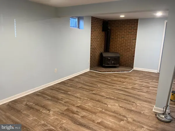 a view of a livingroom with wooden floor and staircase