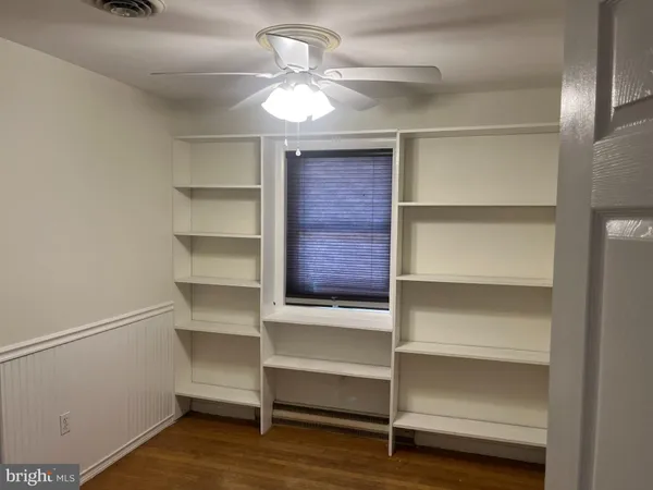 a view of walk in closet with empty racks